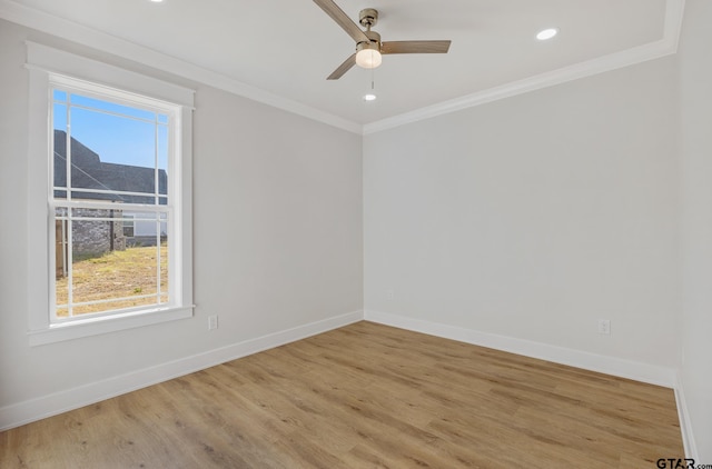 spare room featuring a wealth of natural light, ceiling fan, light hardwood / wood-style floors, and ornamental molding