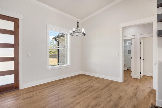 unfurnished dining area with ornamental molding, light wood-type flooring, and a chandelier