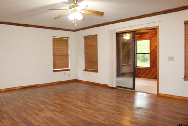 unfurnished room with crown molding, dark wood-type flooring, and ceiling fan