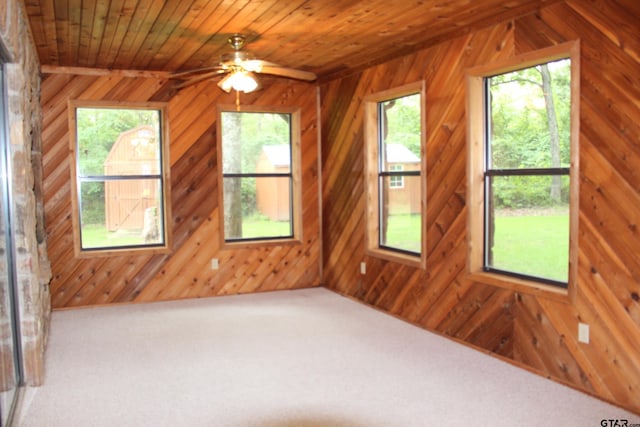 additional living space featuring wood ceiling, wooden walls, ceiling fan, and carpet