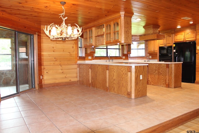 kitchen featuring a notable chandelier, light tile patterned floors, wooden ceiling, and black appliances