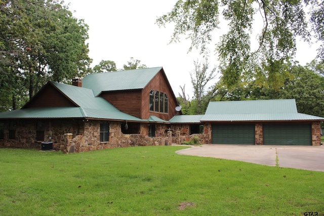 view of front of house featuring a garage, central AC unit, and a front yard