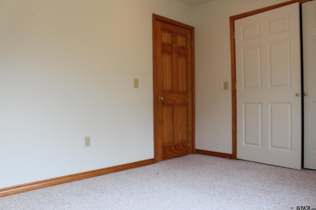 unfurnished room featuring light colored carpet