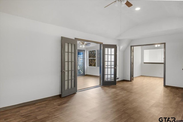 unfurnished room with baseboards, recessed lighting, lofted ceiling, wood finished floors, and ceiling fan