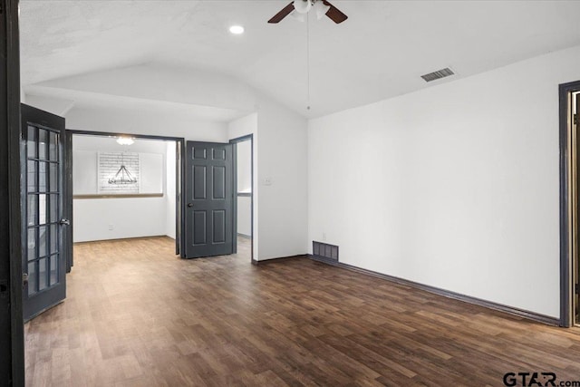 unfurnished room featuring wood finished floors, vaulted ceiling, visible vents, and ceiling fan
