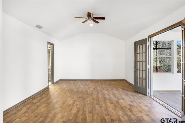 spare room with lofted ceiling, baseboards, a ceiling fan, and wood finished floors