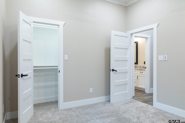 unfurnished bedroom featuring light carpet