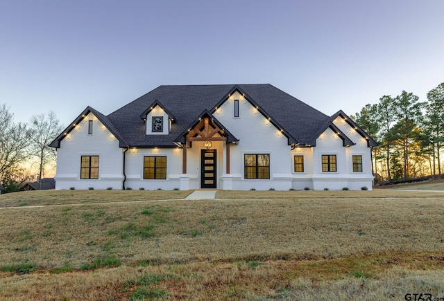 modern farmhouse with a lawn