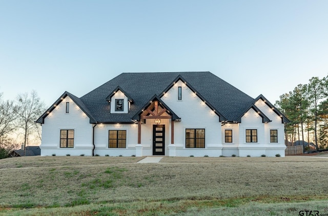 modern farmhouse style home with a yard