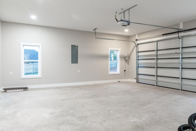 garage with electric panel and a garage door opener