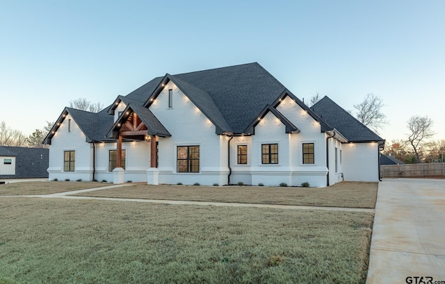 modern farmhouse featuring a lawn