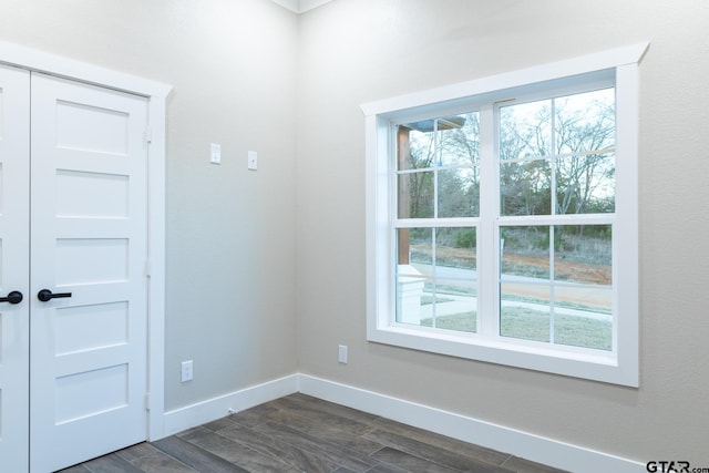 empty room with dark wood-type flooring