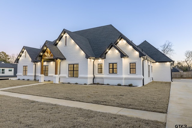 modern inspired farmhouse with a yard