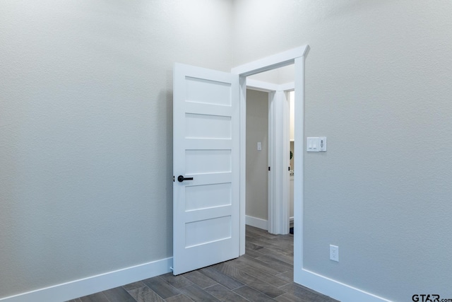 empty room with dark hardwood / wood-style flooring