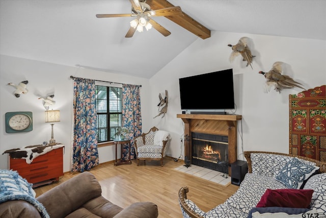 381 Knollwood Ln, Holly Lake Ranch, TX 75765 - living room with a ceiling fan, lofted ceiling with beams, a fireplace with flush hearth, and wood finished floors