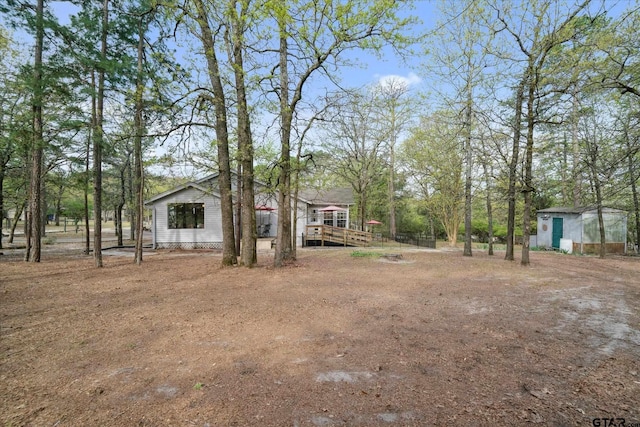 381 Knollwood Ln, Holly Lake Ranch, TX 75765 - view of yard featuring a storage unit and an outdoor structure