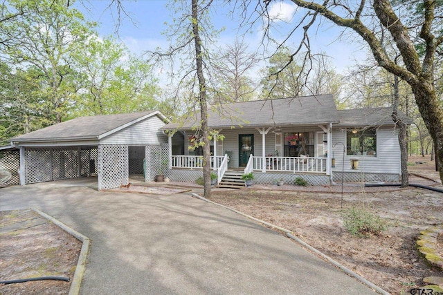 381 Knollwood Ln, Holly Lake Ranch, TX 75765 - ranch-style home with driveway, a porch, and a carport