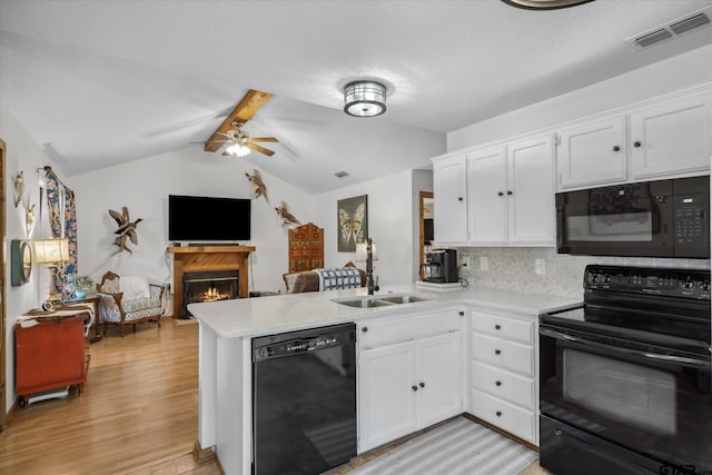 381 Knollwood Ln, Holly Lake Ranch, TX 75765 - kitchen with white cabinetry, light countertops, visible vents, a peninsula, and black appliances