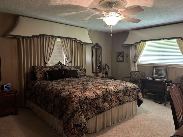 7892 Lakeshore Dr, Tyler, TX 75707 - bedroom featuring light carpet, wooden walls, a textured ceiling, and ceiling fan