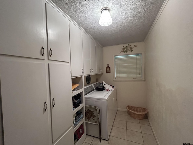 7892 Lakeshore Dr, Tyler, TX 75707 - laundry area with cabinet space, washer and clothes dryer, a textured ceiling, and light tile patterned floors