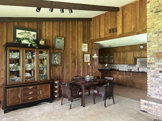 7892 Lakeshore Dr, Tyler, TX 75707 - dining room with light colored carpet, beamed ceiling, and wooden walls