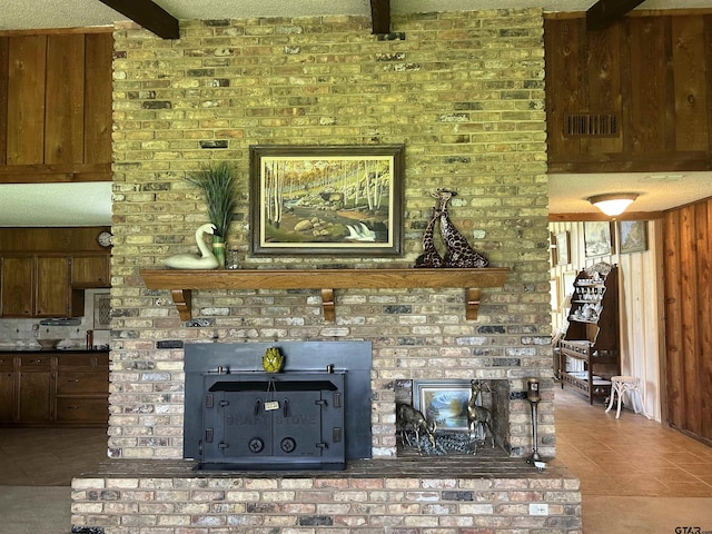 7892 Lakeshore Dr, Tyler, TX 75707 - tiled living area featuring beam ceiling, wooden walls, and a textured ceiling
