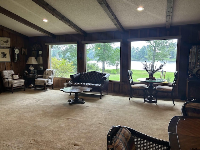 7892 Lakeshore Dr, Tyler, TX 75707 - carpeted living area with a water view, beam ceiling, wooden walls, and a textured ceiling