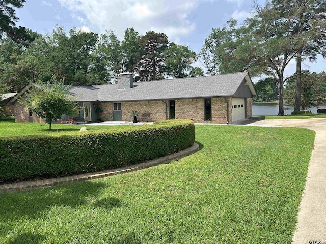 7892 Lakeshore Dr, Tyler, TX 75707 - ranch-style house with driveway, a front yard, an attached garage, brick siding, and a chimney