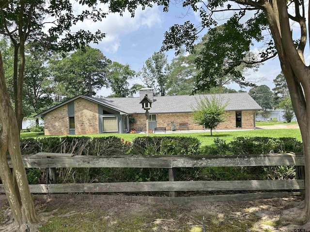 7892 Lakeshore Dr, Tyler, TX 75707 - view of front of home with brick siding and a chimney