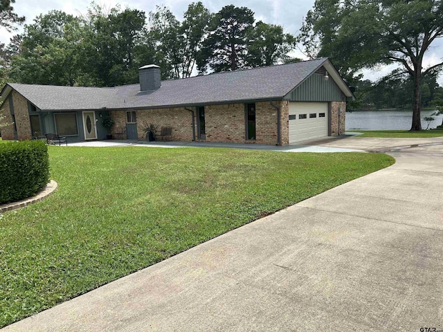 7892 Lakeshore Dr, Tyler, TX 75707 - ranch-style home with brick siding, driveway, a front yard, a chimney, and a water view