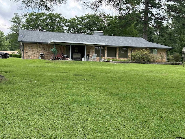 7892 Lakeshore Dr, Tyler, TX 75707 - ranch-style home featuring a front yard, brick siding, and a chimney