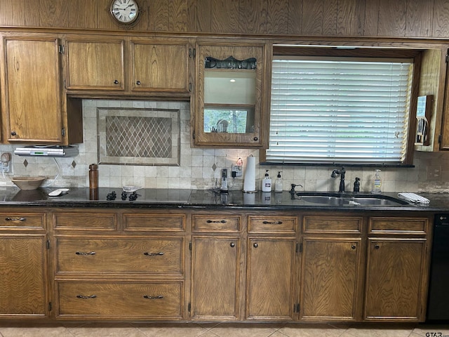 7892 Lakeshore Dr, Tyler, TX 75707 - kitchen with backsplash, dark stone counters, brown cabinetry, and dishwashing machine