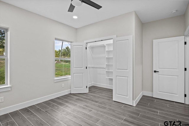 unfurnished bedroom with dark wood-type flooring, ceiling fan, and a closet