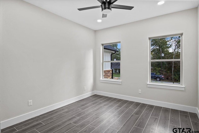 spare room with dark wood-type flooring and ceiling fan