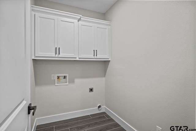 washroom with hookup for a washing machine, dark hardwood / wood-style flooring, electric dryer hookup, and cabinets