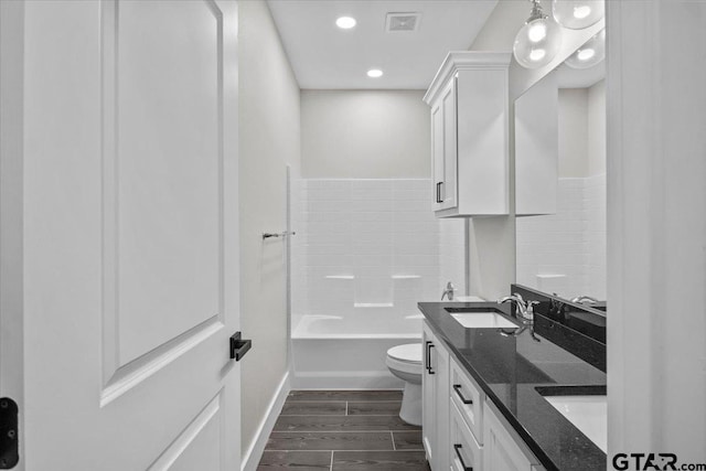 full bathroom with toilet, hardwood / wood-style floors, decorative backsplash, vanity, and bathing tub / shower combination