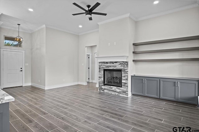 unfurnished living room with a fireplace, dark hardwood / wood-style flooring, and crown molding