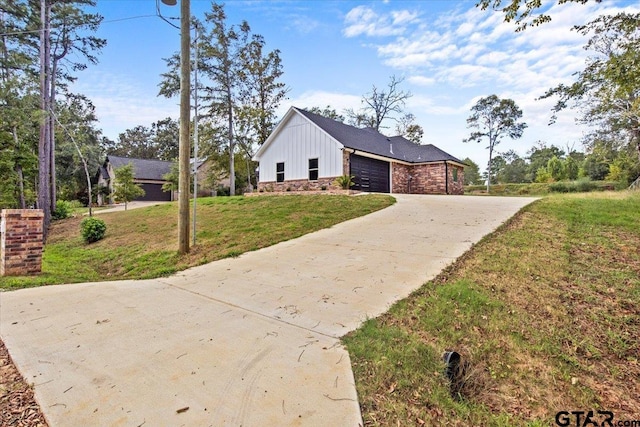 view of side of home featuring a garage and a yard