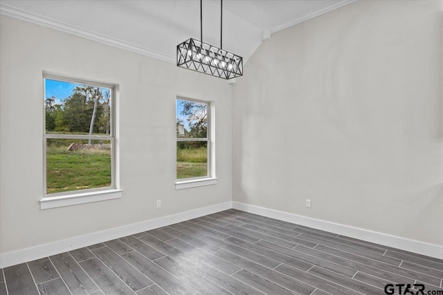 unfurnished dining area featuring ornamental molding, dark wood-type flooring, a chandelier, and vaulted ceiling