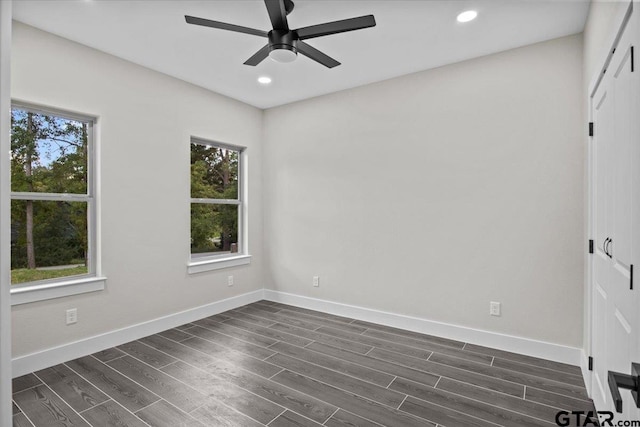 spare room featuring ceiling fan and dark hardwood / wood-style flooring