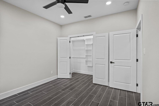 unfurnished bedroom featuring ceiling fan, dark hardwood / wood-style floors, and a closet