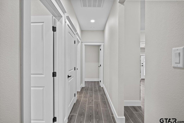 corridor with dark wood-type flooring