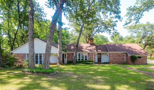 2115 Heather Ln, Tyler, TX 75703 - ranch-style house featuring brick siding, a front yard, and a chimney