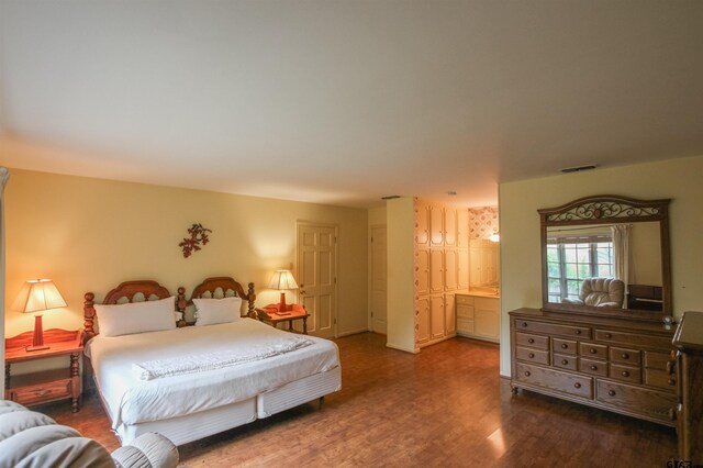 2115 Heather Ln, Tyler, TX 75703 - bedroom with wood finished floors and ensuite bathroom