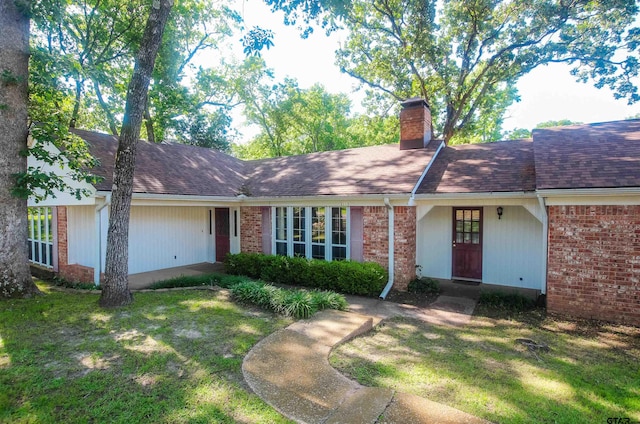 2115 Heather Ln, Tyler, TX 75703 - single story home featuring a chimney, a front lawn, brick siding, and roof with shingles
