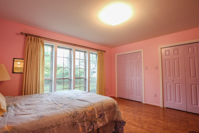 2115 Heather Ln, Tyler, TX 75703 - bedroom with multiple closets, wood finished floors, and baseboards