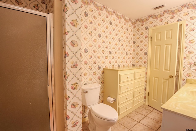 2115 Heather Ln, Tyler, TX 75703 - full bath with vanity, wallpapered walls, a shower stall, toilet, and tile patterned floors