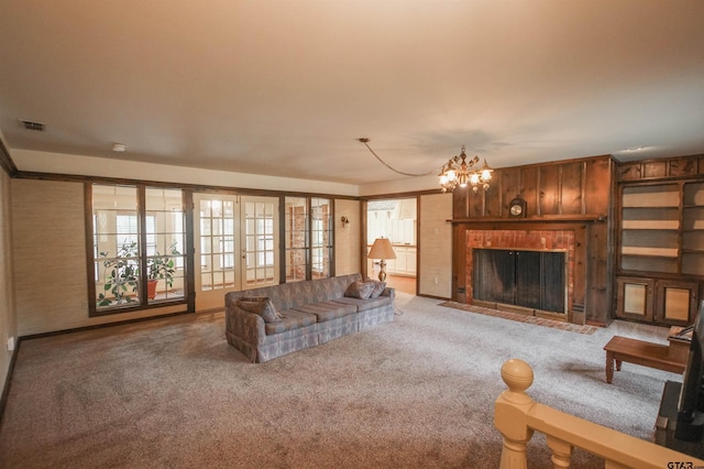 2115 Heather Ln, Tyler, TX 75703 - living room with carpet flooring, a chandelier, and a fireplace with flush hearth