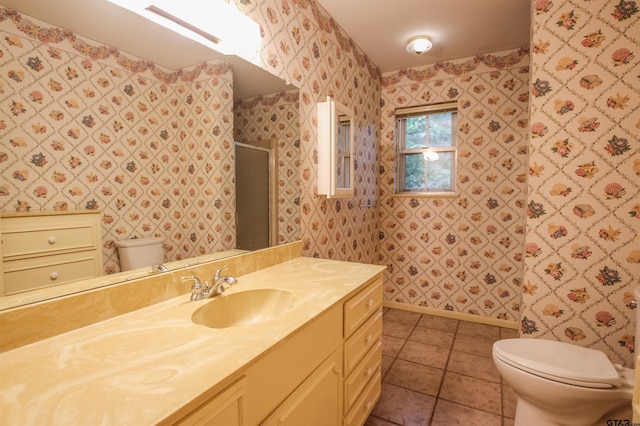 2115 Heather Ln, Tyler, TX 75703 - full bathroom featuring toilet, a shower with shower door, vanity, tile patterned flooring, and wallpapered walls
