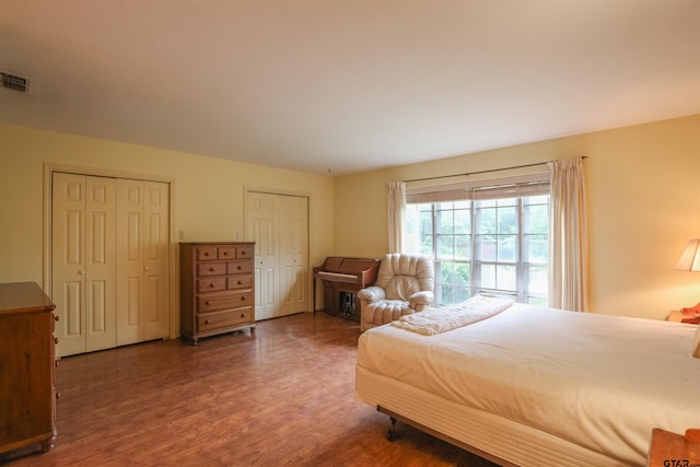 2115 Heather Ln, Tyler, TX 75703 - bedroom with wood finished floors and multiple closets